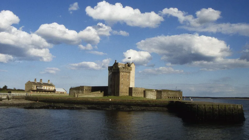 Broughty Castle and the harbour at Broughty Ferry, under a blue sky