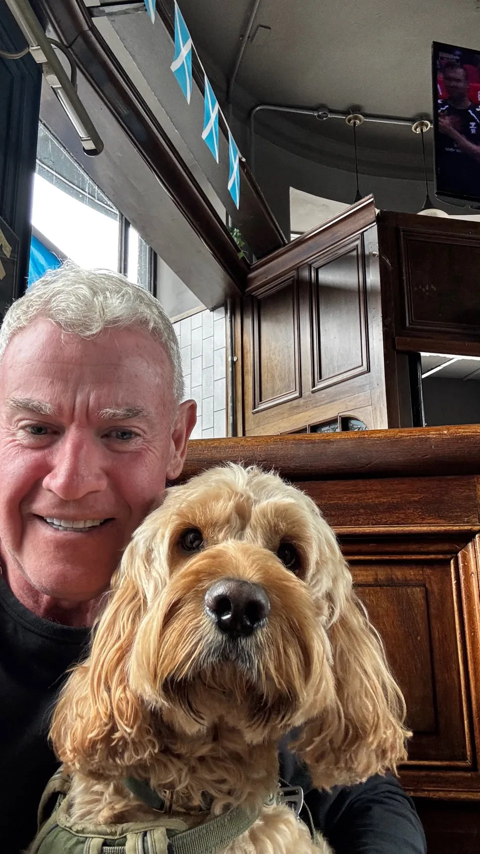 Ruben, a fluffy golden dog, with Craig in The Granary pub in Shawlands
